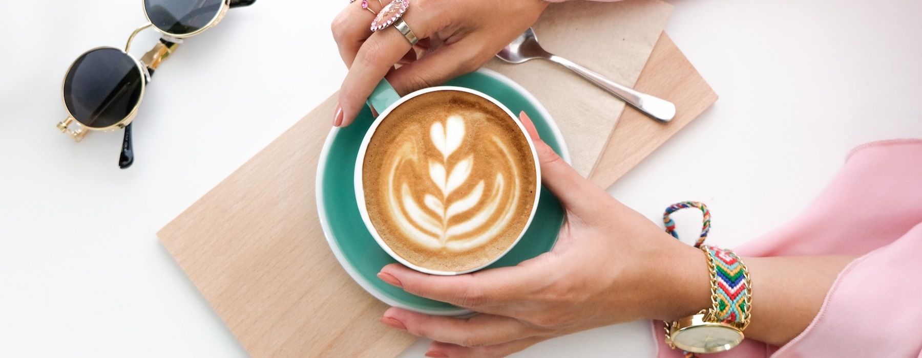 a woman holding a cup of coffee